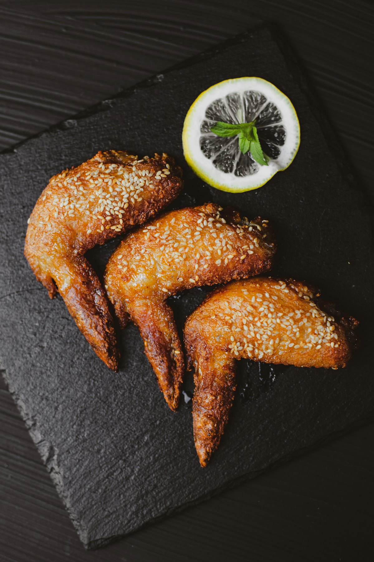 Stock photo of crispy fried chicken wings with lemon and salt — placeholder, not their kitchen