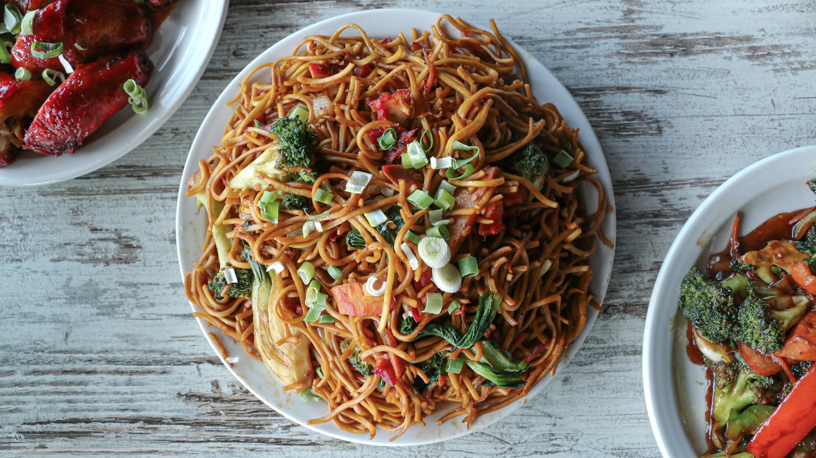 Stock photo of a plate of stir-fried chow mein noodles with vegetables — placeholder, not their kitchen