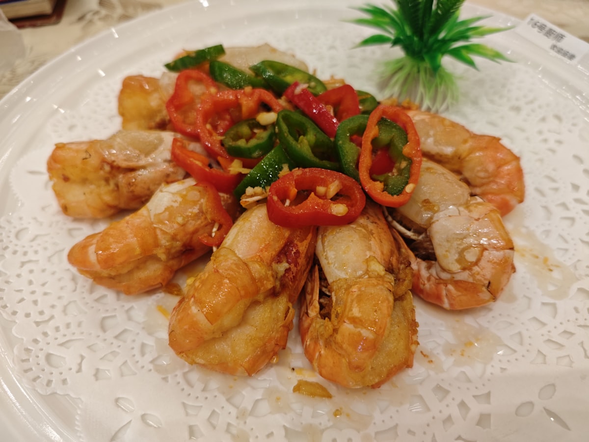 Stock photo of crispy salt-and-pepper prawns with chilli and scallion — placeholder, not their kitchen