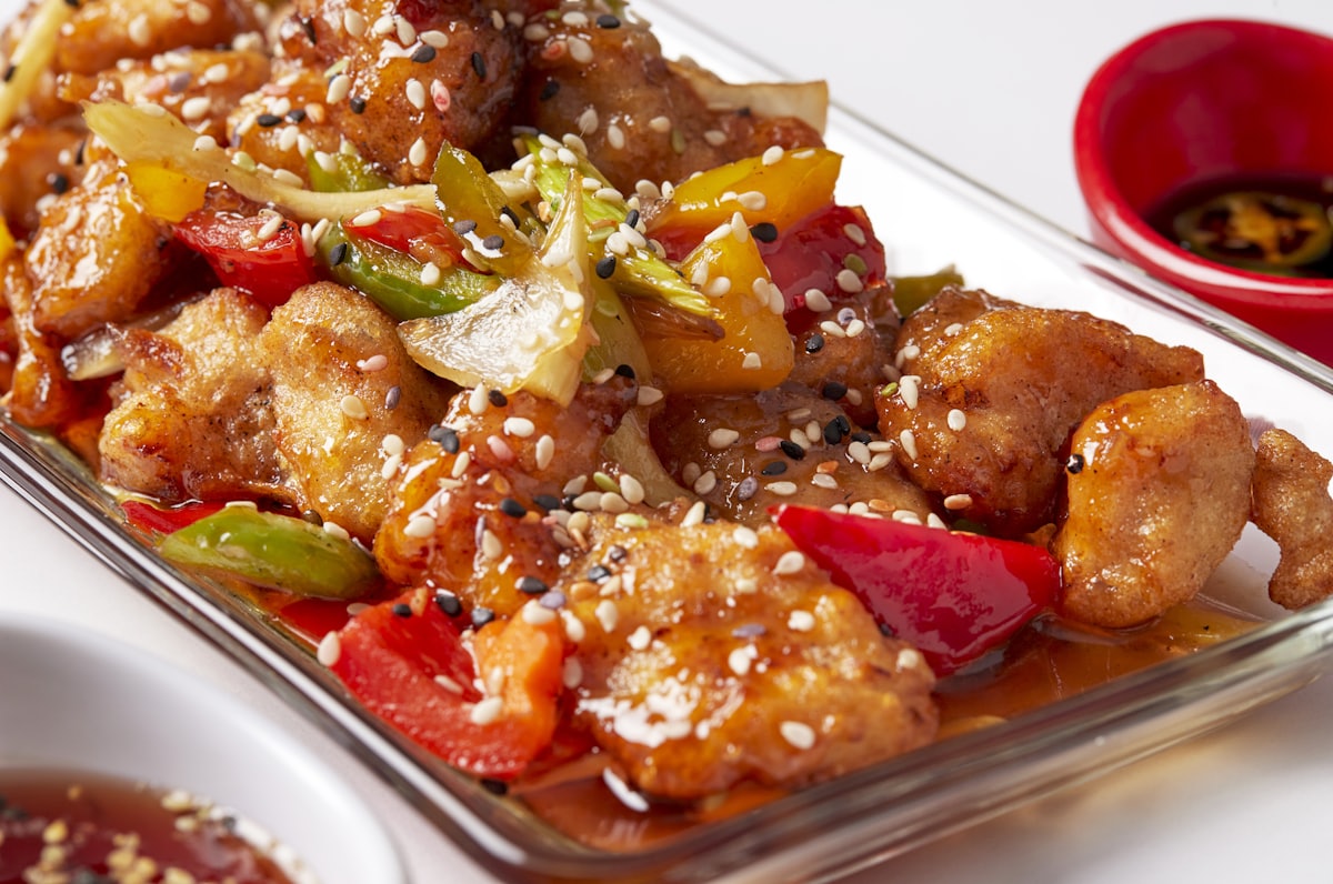 Stock photo of battered sweet-and-sour pork with pineapple and peppers — placeholder, not their kitchen