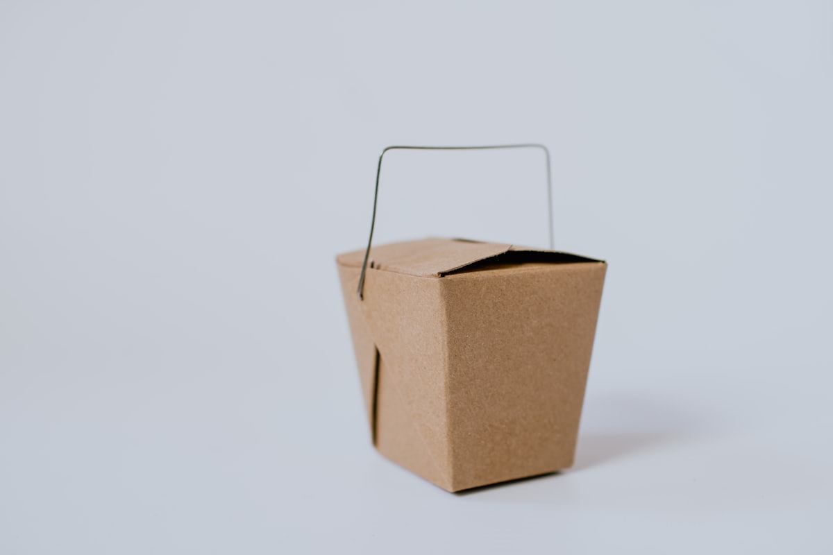 Stock photo of a kraft-paper Chinese takeout box — placeholder, not their kitchen